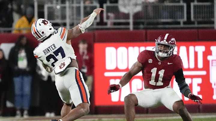Nov 30, 2024; Tuscaloosa, Alabama, USA;  Auburn Tigers running back Jarquez Hunter (27) throws a pass against Alabama Crimson Tide linebacker Jihaad Campbell (11) during the second half at Bryant-Denny Stadium. The pass was intercepted. Alabama won 28-14. Mandatory Credit: Gary Cosby Jr.-Imagn Images