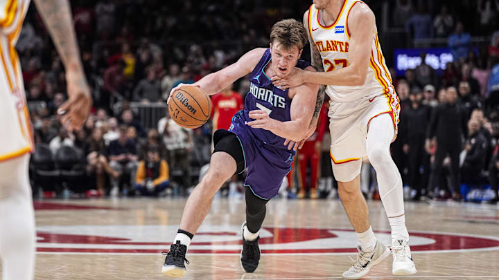 Nov 23, 2025; Atlanta, Georgia, USA; Charlotte Hornets guard Kon Knueppel (7) tries to dribble past Atlanta Hawks guard Vit Krejci (27) during the second half at State Farm Arena. Mandatory Credit: Dale Zanine-Imagn Images