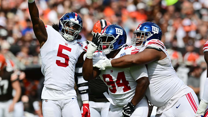 New York Giants linebacker Kayvon Thibodeaux (5) and defensive tackle Elijah Chatman (94) and defensive tackle Dexter Lawrence II (97) celebrate.