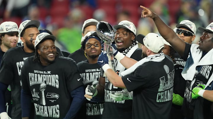 Feb 8, 2026; Santa Clara, CA, USA;  Seattle Seahawks players celebrate with the Vince Lombardi Trophy after defeating the New England Patriots in Super Bowl LX at Levi's Stadium. Mandatory Credit: Kirby Lee-Imagn Images