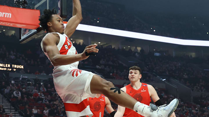 Mar 16, 2025; Portland, Oregon, USA;  Toronto Raptors forward Scottie Barnes (4) passes the ball away from Portland Trail Blazers center Donovan Clingan (23)in the first half at Moda Center. Mandatory Credit: Jaime Valdez-Imagn Images