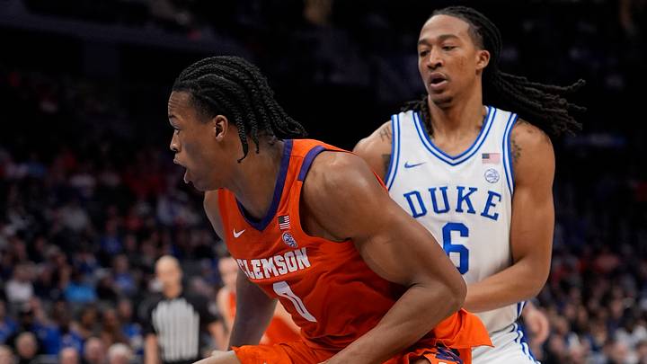 Mar 13, 2026; Charlotte, NC, USA; Clemson Tigers forward RJ Godfrey (0) goes to the basket defended by Duke Blue Devils forward Maliq Brown (6) during the second half at Spectrum Center.
