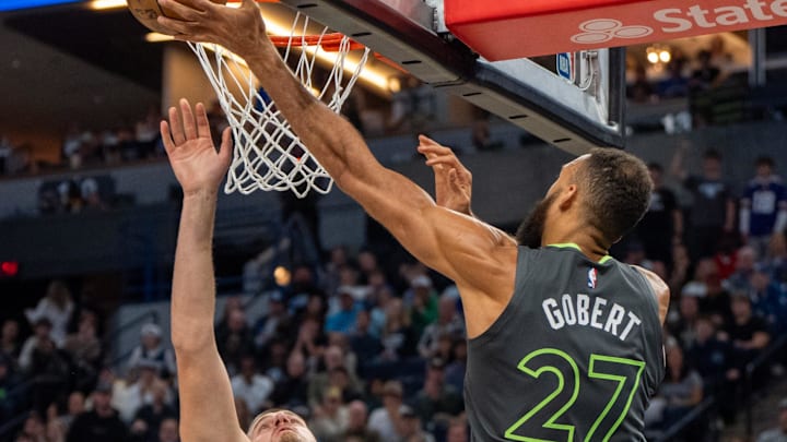 Nov 1, 2024; Minneapolis, Minnesota, USA; Minnesota Timberwolves center Rudy Gobert (27) shoots over Denver Nuggets center Nikola Jokic (15) in the second quarter at Target Center. Mandatory Credit: Matt Blewett-Imagn Images