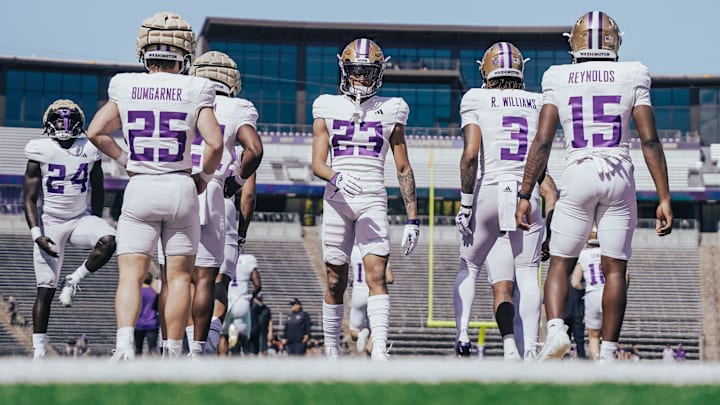 Husky offensive players get loose during practice. Husky offensive players get loose during practice.