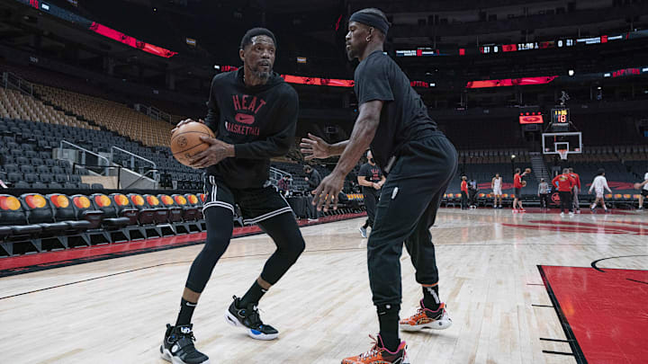 Feb 1, 2022; Toronto, Ontario, CAN; Miami Heat forward Udonis Haslem (40) controls the ball as forward Jimmy Butler (22) tries to defend during the warms up against the Toronto Raptors at Scotiabank Arena. Mandatory Credit: Nick Turchiaro-Imagn Images