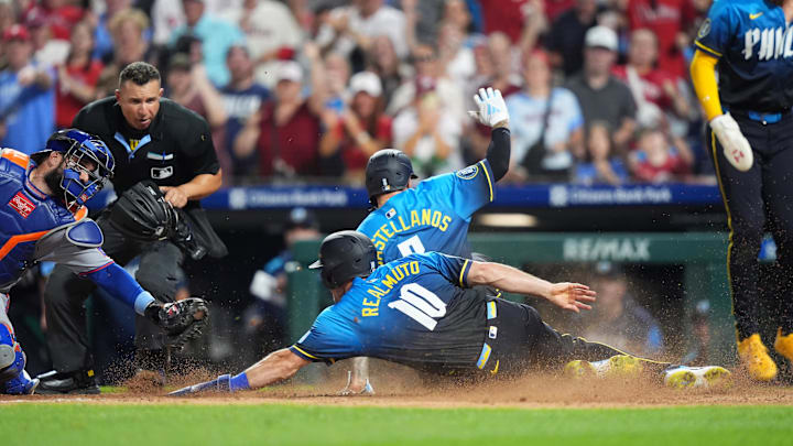 Jun 20, 2025; Philadelphia, Pennsylvania, USA; Philadelphia Phillies catcher J.T. Realmuto (10) and outfielder Nick Castellanos (8) advance home to score against the New York Mets in the seventh inning at Citizens Bank Park.