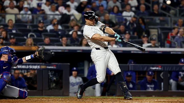 Oct 30, 2024; New York, New York, USA; New York Yankees designated hitter Giancarlo Stanton (27) hits a home run during the third inning against the Los Angeles Dodgers in game five of the 2024 MLB World Series at Yankee Stadium. Mandatory Credit: Vincent Carchietta-Imagn Images