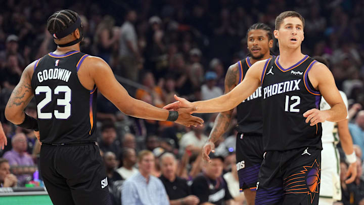 Mar 21, 2026; Phoenix, Arizona, USA; Phoenix Suns guard Jordan Goodwin (23) and Phoenix Suns guard Collin Gillespie (12) slap hands against the Milwaukee Bucks during the first half at Mortgage Matchup Center. Mandatory Credit: Joe Camporeale-Imagn Images