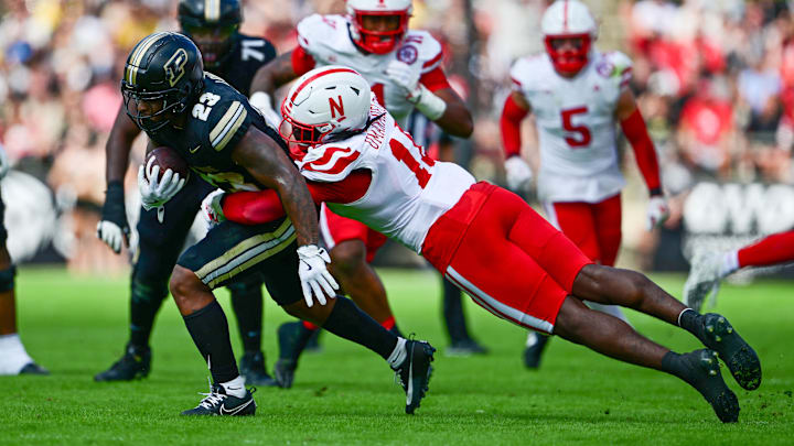 Sep 28, 2024; West Lafayette, Indiana, USA; Purdue Boilermakers running back Reggie Love III (23) is tackled by Nebraska Cornhuskers linebacker Princewill Umanmielen (18) during the second half at Ross-Ade Stadium. Mandatory Credit: Marc Lebryk-Imagn Images