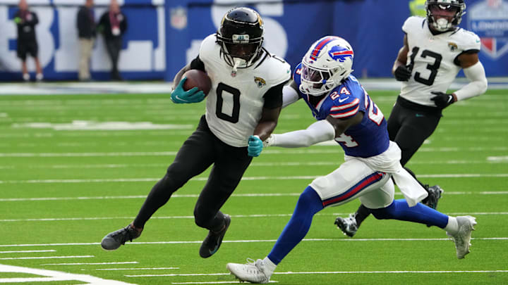 Oct 8, 2023; London United Kingdom, Jacksonville Jaguars wide receiver Calvin Ridley (0) carries the ball against Buffalo Bills cornerback Kaiir Elam (24) during the second half of an NFL International Series game at Tottenham Hotspur Stadium. 