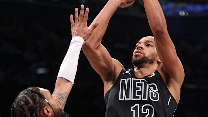Feb 4, 2025; Brooklyn, New York, USA; Brooklyn Nets forward Tosan Evbuomwan (12) shoots the ball as Houston Rockets forward Cam Whitmore (7) defends during the second half at Barclays Center. Mandatory Credit: Vincent Carchietta-Imagn Images