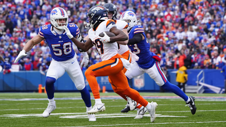 Jan 12, 2025; Orchard Park, New York, USA; Denver Broncos wide receiver Marvin Mims Jr. (19) runs for a gain as Buffalo Bills linebacker Matt Milano (58) defends