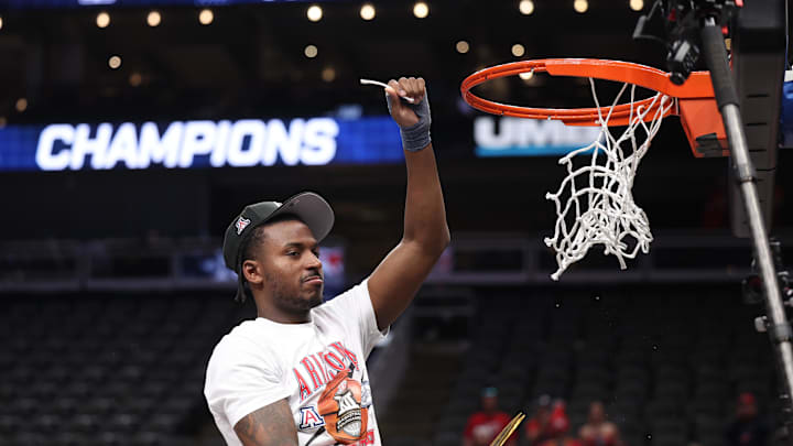 Mar 14, 2026; Kansas City, MO, USA; Arizona Wildcats guard Jaden Bradley (0) cuts the net following a win over the Houston Cougars during the men's Big 12 Conference Tournament Championship at T-Mobile Center. Mandatory Credit: William Purnell-Imagn Images Mar 14, 2026; Kansas City, MO, USA; Arizona Wildcats guard Jaden Bradley (0) cuts the net following a win over the Houston Cougars during the men's Big 12 Conference Tournament Championship at T-Mobile Center. Mandatory Credit: William Purnell-Imagn Images