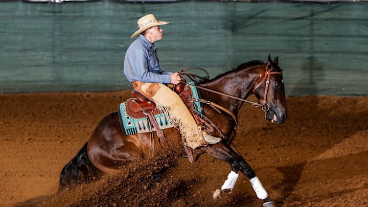 NRCHA Open Rider Braden Johns competes in a performance horse event. 