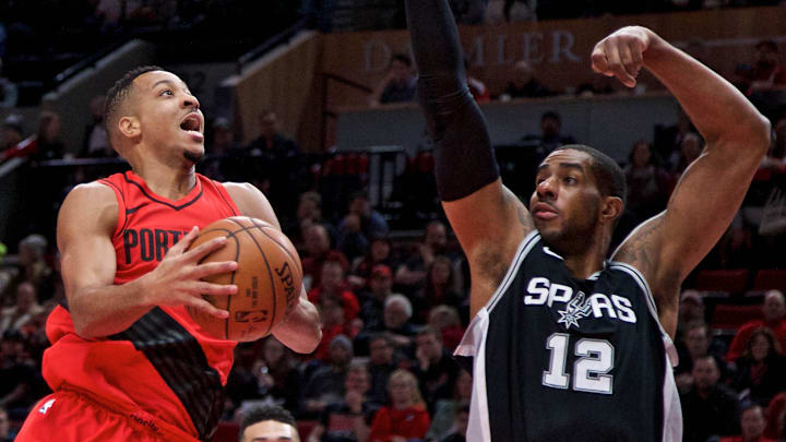 Dec 20, 2017; Portland, OR, USA: Portland Trail Blazers guard CJ McCollum (3) shoots over San Antonio Spurs forward LaMarcus Aldridge (12) during the first quarter at the Moda Center. Mandatory Credit: Craig Mitchelldyer-Imagn Images