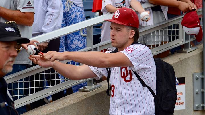 Oklahoma pitcher Cord Rager signs autographs before Game 2 of the CWS Finals.