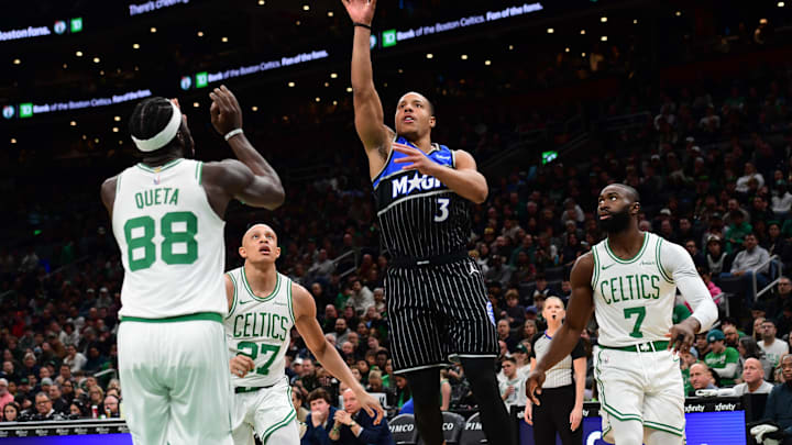 Nov 23, 2025; Boston, Massachusetts, USA;  Orlando Magic guard Desmond Bane (3) shoots the ball while Boston Celtics center Neemias Queta (88), guard Jordan Walsh (27) and guard Jaylen Brown (7) look on during the first half at TD Garden. Mandatory Credit: Bob DeChiara-Imagn Images