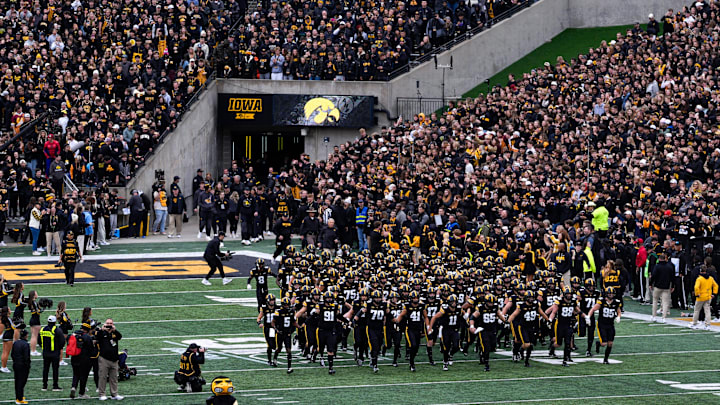 The Iowa Hawkeyes swarm onto the field ahead of a football game against the Minnesota Golden Gophers Oct. 25, 2025 at Kinnick Stadium in Iowa City, Iowa.