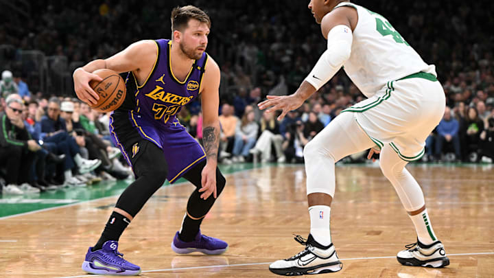 Mar 8, 2025; Boston, Massachusetts, USA; Los Angeles Lakers guard Luka Doncic (77) drives to the basket against Boston Celtics center Al Horford (42) during the second quarter at the TD Garden.