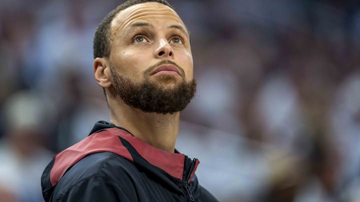 Golden State Warriors guard Stephen Curry (30) looks on from the bench against the Minnesota Timberwolves.