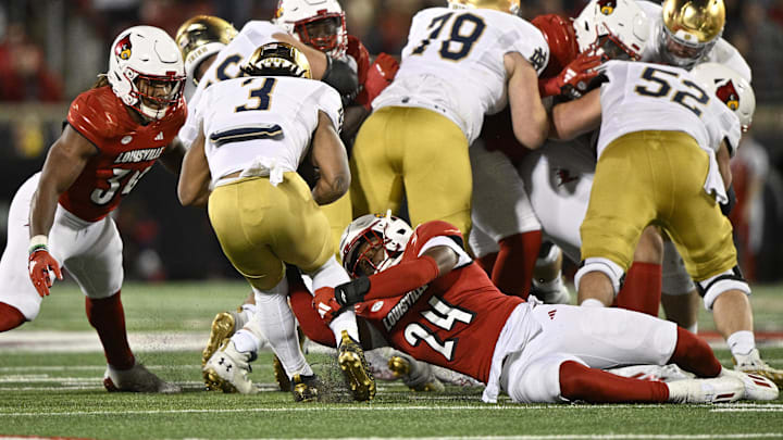 Oct 7, 2023; Louisville, Kentucky, USA; Louisville Cardinals linebacker Jaylin Alderman (24) tackles Notre Dame Fighting Irish running back Gi'Bran Payne (3) during the second half at L&N Federal Credit Union Stadium. Louisville defeated Notre Dame 33-20. Mandatory Credit: Jamie Rhodes-Imagn Images Oct 7, 2023; Louisville, Kentucky, USA; Louisville Cardinals linebacker Jaylin Alderman (24) tackles Notre Dame Fighting Irish running back Gi'Bran Payne (3) during the second half at L&N Federal Credit Union Stadium. Louisville defeated Notre Dame 33-20. Mandatory Credit: Jamie Rhodes-Imagn Images