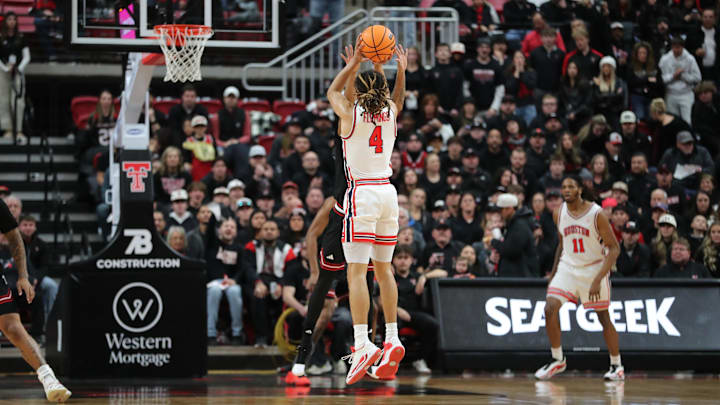 Jan 24, 2026; Lubbock, Texas, USA;  Houston Cougars guard Kingston Flemings (4) takes a shot over Texas Tech Red Raiders Texas Tech Red Raiders forward LeJuan Watts (3) in the first half at United Supermarkets Arena. 