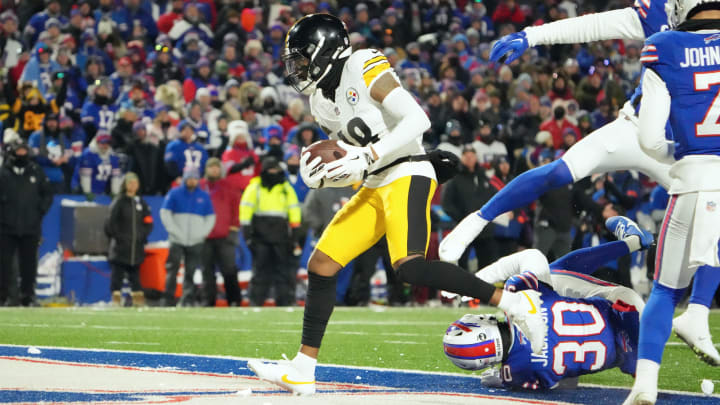 Jan 15, 2024; Orchard Park, New York, USA; Pittsburgh Steelers wide receiver Diontae Johnson (18) runs the ball in for a touch-down in the first half against the Buffalo Bills in a 2024 AFC wild card game at Highmark Stadium. Mandatory Credit: Kirby Lee-USA TODAY Sports