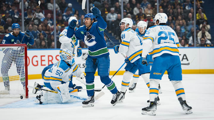Oct 13, 2025; Vancouver, British Columbia, CAN; St. Louis Blues forward Jordan Kyrou (25) watches as Vancouver Canucks forward Kiefer Sherwood (44) scores his first goal of the period on goalie Jordan Binnington (50) in the second period at Rogers Arena. Mandatory Credit: Bob Frid-Imagn Images