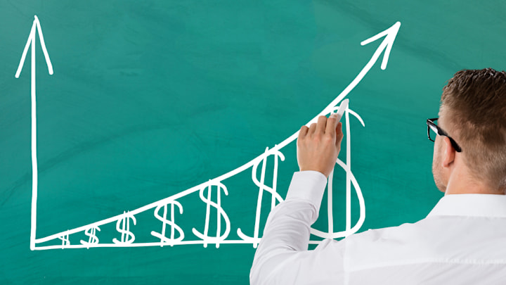 Teacher drawing a graph on a chalkboard