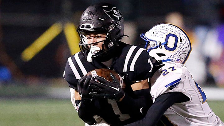 Ontario High School's Tre Fowler (27) tackles Perkins High School's Braylon Collier (1) during their OHSAA Division IV Region 14 championship high school football game Friday, Nov. 22, 2024 at Tiffin Frost Kalnow Stadium. TOM E. PUSKAR/MANSFIELD NEWS JOURNAL