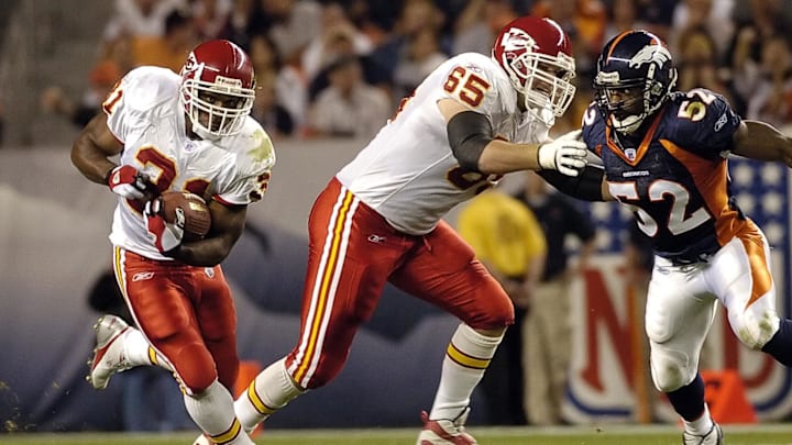 Sep 26, 2005; Denver, CO, USA; Kansas City Chiefs running back Priest Holmes #31 runs through a hole as tackle Jordan Black #65 blocks Denver Broncos linebacker Ian Gold in the second quarter at Invesco Field at Mile High. 