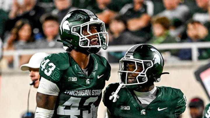 Michigan State's Malik Spencer, left, celebrates a stop with Charles Brantley during the first quarter in the game against Ohio State on Saturday, Sept. 28, 2024, at Spartan Stadium in East Lansing.