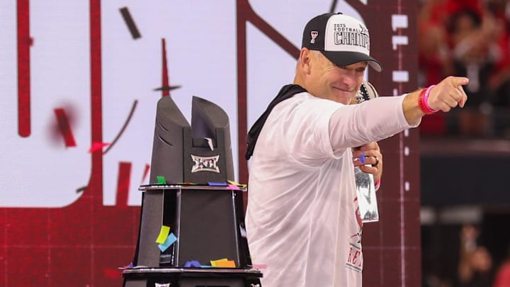 Texas Tech head coach Joey McGuire holds the trophy on stage after the Big 12 Conference championship football game.