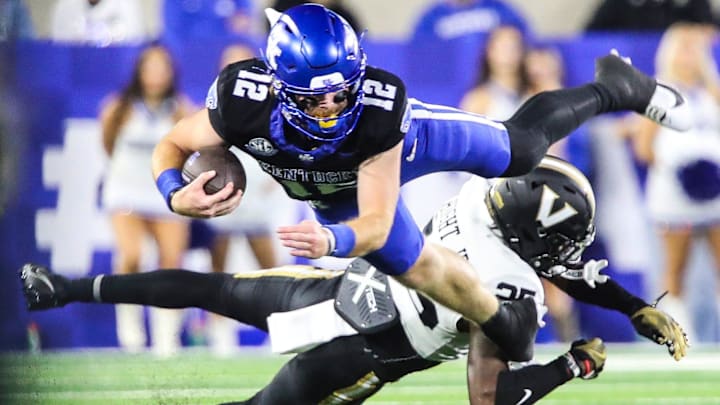 Quarterback Brock Vandagriff (12) dives as he's tackled by cornerback Martel Hight (25) of the Vanderbilt Commodores. The Commodores defeated the Wildcats 20-13 at Kroger Field Saturday, Oct. 12, 2024 in Lexington, Ky.