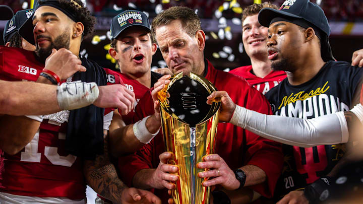 Indiana Head Coach Curt Cignetti prepares to lift the trophy on the podium after the College Football Playoff National Championship college football game at Hard Rock Stadium in Miami Gardens on Monday, Jan. 19, 2026.