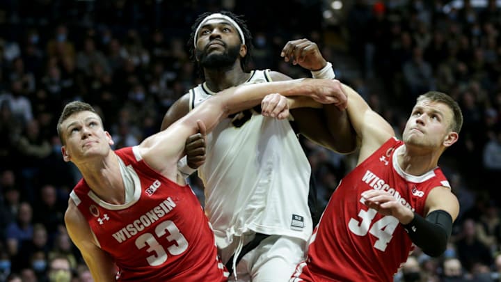 Purdue forward Trevion Williams (50) is boxed out by Wisconsin center Chris Vogt (33) and Wisconsin guard Brad Davison (34) during the second half of an NCAA men's basketball game, Monday, Jan. 3, 2022 at Mackey Arena in West Lafayette.

Bkc Purdue Vs Wisconsin