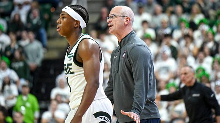 UConn’s head coach Dan Hurley, right, argues with a referee as Michigan State’s Jeremy Fears Jr. stands by during the first half on Tuesday, Oct. 20, 2026, at the Breslin Center in East Lansing.