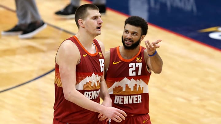 Denver Nuggets center Nikola Jokic (15) talks to guard Jamal Murray.