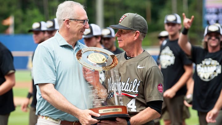 SEC Commissioner Greg Sankey presents the trophy to Vanderbilt Commodores head coach Tim Corbin as Ole Miss Rebels take on Vanderbilt Commodores during the SEC baseball tournament championship game at Hoover Met in Birmingham, Ala., on Sunday, May 25, 2025. Vanderbilt Commodores defeated Ole Miss Rebels 3-2.