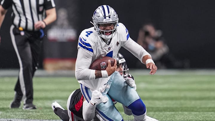 Nov 3, 2024; Atlanta, Georgia, USA; Dallas Cowboys quarterback Dak Prescott (4) is tackled from behind by Atlanta Falcons linebacker Kaden Elliss (55) during the second half at Mercedes-Benz Stadium. Mandatory Credit: Dale Zanine-Imagn Images