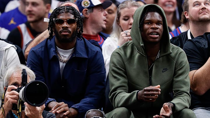 University of Colorado Buffaloes football players Shedeur Sanders and Travis Hunter watch during the third period between the Denver Nuggets and the Los Angeles Lakers.