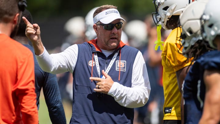 Auburn Tigers head coach Hugh Freeze talks with wide receiver Cam Coleman (8) during practice at Woltosz Football Performance Center in Auburn, Ala. on Thursday, Aug. 14, 2025.