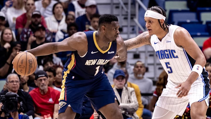 Apr 3, 2024; New Orleans, Louisiana, USA;  New Orleans Pelicans forward Zion Williamson (1) dribbles against Orlando Magic forward Paolo Banchero (5) during the first half at Smoothie King Center. Mandatory Credit: Stephen Lew-Imagn Images
