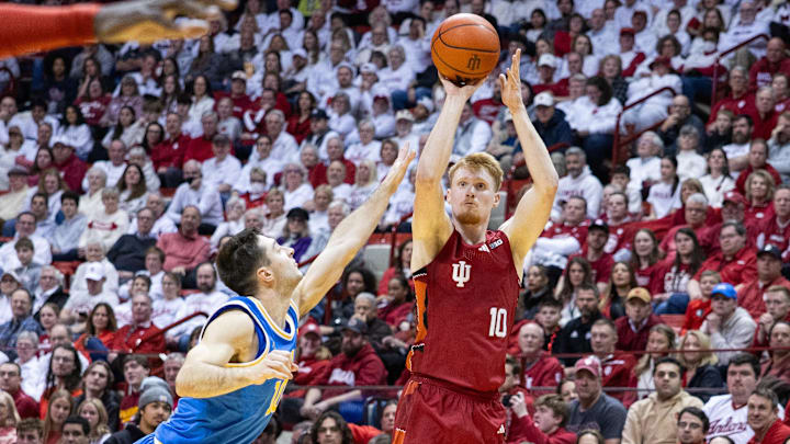Feb 14, 2025; Bloomington, Indiana, USA; Indiana Hoosiers forward Luke Goode (10) shoots the ball while UCLA Bruins guard Lazar Stefanovic (10) defends in the first half at Simon Skjodt Assembly Hall. Mandatory Credit: Trevor Ruszkowski-Imagn Images