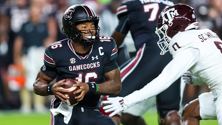Nov 2, 2024; Columbia, South Carolina, USA; South Carolina Gamecocks quarterback LaNorris Sellers (16) eludes a sack by Texas A&M Aggies linebacker Scooby Williams (0) in the first quarter at Williams-Brice Stadium.