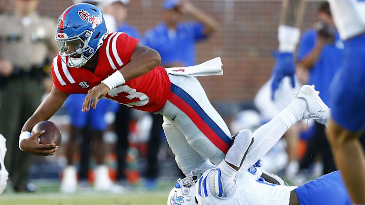 Sep 7, 2024; Oxford, Mississippi, USA; Mississippi Rebels quarterback Austin Simmons (13) dives forward as he is tackled by Middle Tennessee Blue Raiders defensive back Rickey Smith (27) during the second half at Vaught-Hemingway Stadium. Mandatory Credit: Petre Thomas-Imagn Images