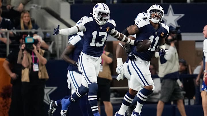 Dallas Cowboys LB DeMarvion Overshown celebrates after scoring on a touchdown interception against the New York Giants.