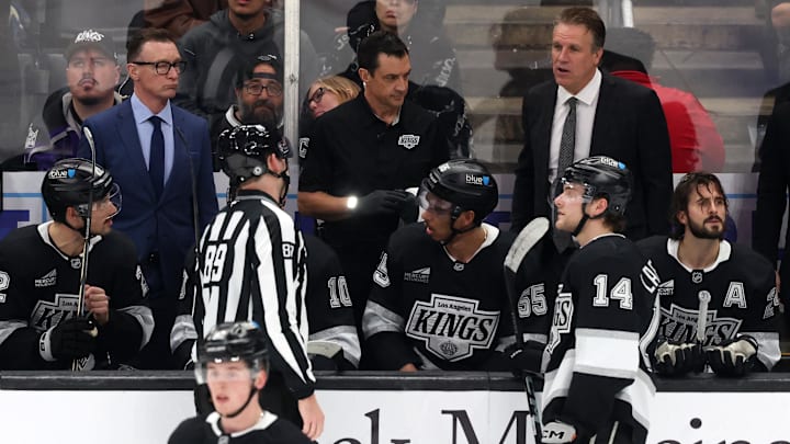 Nov 20, 2024; Los Angeles, California, USA;  Los Angeles Kings head coach Jim Hiller (back row on right) talks to an official during the third period at Crypto.com Arena. Mandatory Credit: Kiyoshi Mio-Imagn Images