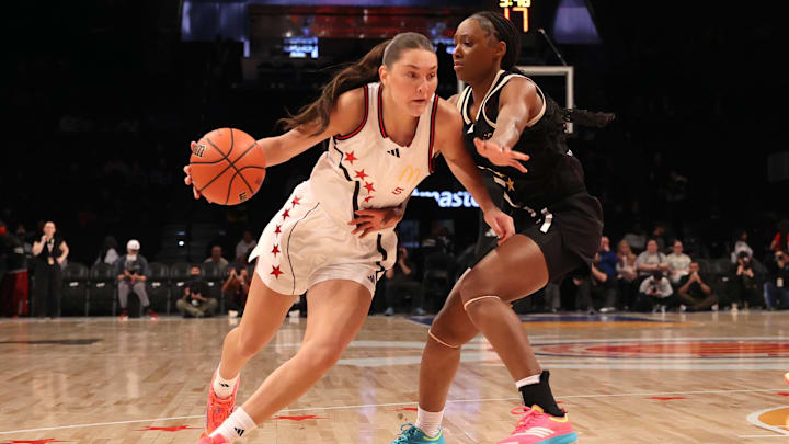 McDonald's All American West guard Emilee Skinner drives to the basket against McDonald's All American East guard Hailee Swain during the first half of the game at Barclays Center. Both will be Team USA teammates in the Nike Hoop Summit on Saturday.
