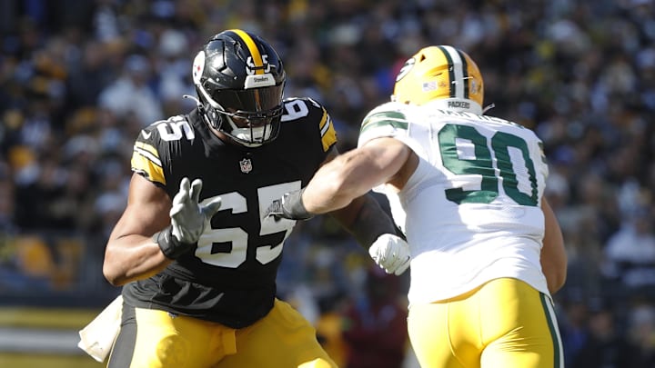 Nov 12, 2023; Pittsburgh, Pennsylvania, USA;  Pittsburgh Steelers offensive tackle Dan Moore Jr. (65) blocks at the line of scrimmage against Green Bay Packers linebacker Lukas Van Ness (90) during the second quarter at Acrisure Stadium. Mandatory Credit: Charles LeClaire-Imagn Images